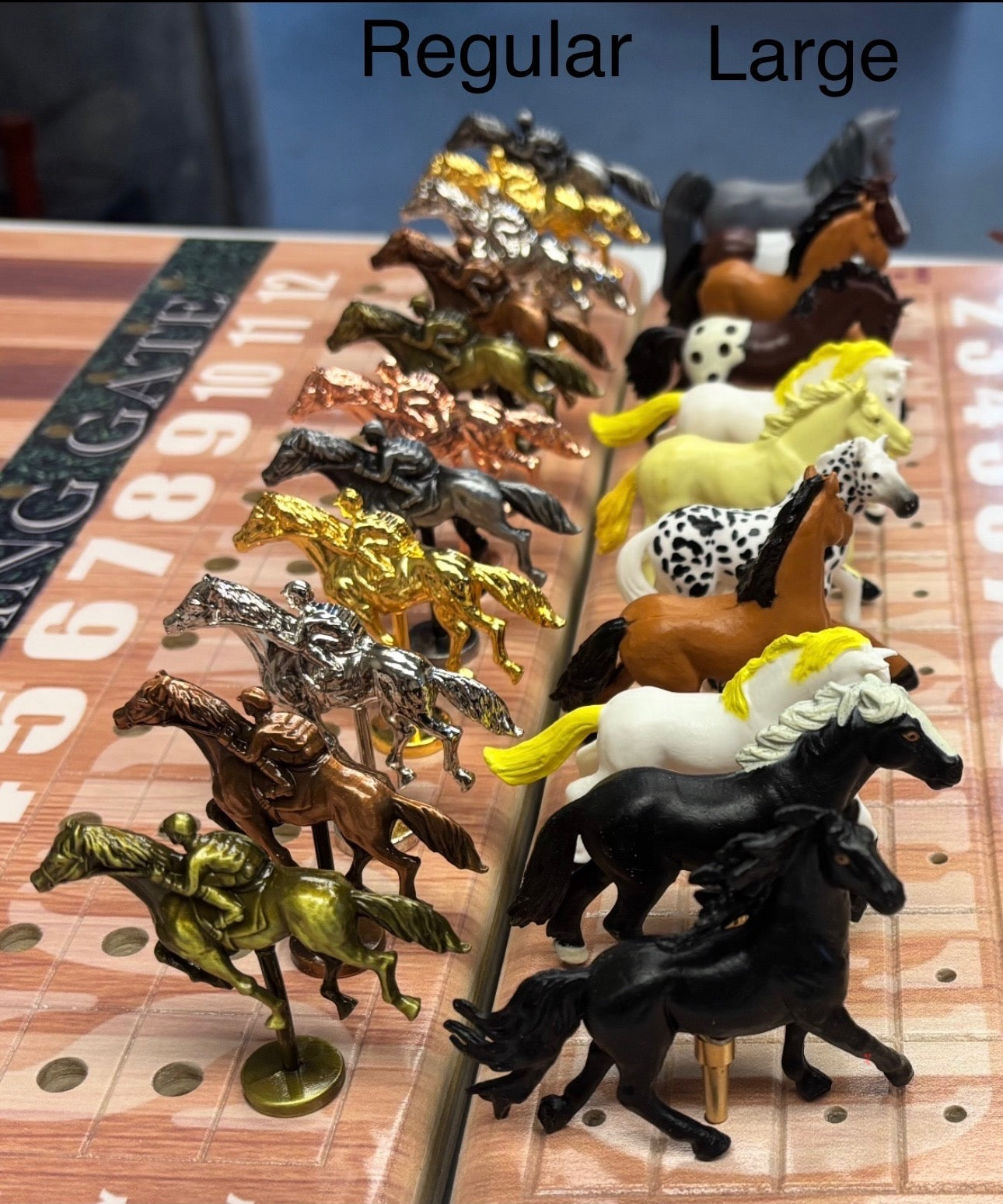 a row of toy horses sitting on top of a table