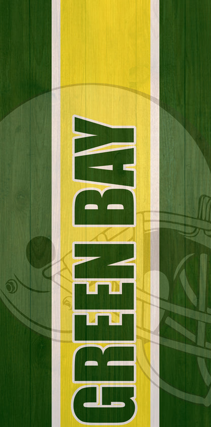 a close up of a green and yellow sign on a wooden surface